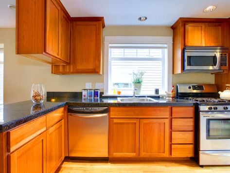 How to fix your dated orange wood cabinets and floors—even if you rent - NewsBreak Make Oak Cabinets Look Modern, Kitchen With Orange Wood Cabinets, Orange Cabinets Kitchen, Orange Wood Cabinets, Orange Wood Cabinets Kitchen, Wood Cabinets And Floors, Orange Cabinets, Wood Cabinet Doors, Pantry Bin