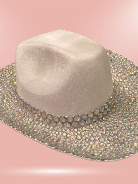 This custom made bedazzled cowboy hat is perfect for a bachelorette party to make sure the bride stands out and great for country music concerts, festivals, and costumes. Cowboy hat shown is covered in iridescent gems along both the top of the rim and underneath the rim. Bedazzled Cowboy Hat, Festival Bachelorette Party, Festival Bachelorette, Rhinestone Cowboy Hat, Country Music Concert, Rhinestone Cowboy, Country Music Concerts, Music Concerts, Concert Festival