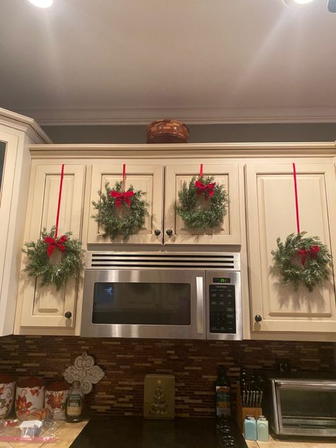 Black Kitchen Cabinets Christmas Decor, Christmas Over Cabinet Decor, Above The Cabinets Christmas Decor, Christmas Present Cabinets, Wreaths Kitchen Cabinets, Christmas Decorations For Cabinets, Kitchen Cabinet Top Decorating Ideas For Christmas, Christmas Decor Ideas For Kitchen Cabinets, Christmas Above Kitchen Cabinets