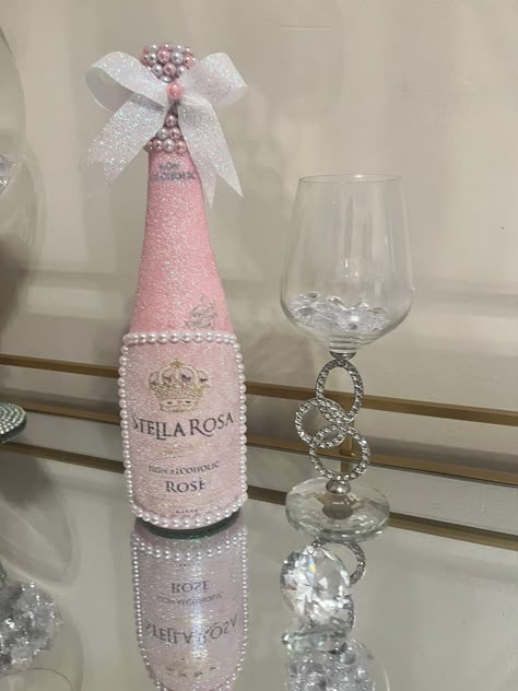 Beautiful hand decorated bottle with sparkling iridescent pink glitter.  Pearl gem border. Stunning pearl detail on the neck. This bottle is sold empty and the gemstone cap is sealed shut. This glam bottle is the perfect addition to your room, a gift, or table centerpiece for your special occasion. Please contact me if a larger quantity is needed, or with any other questions.  Perfect to use for:  - home decor - bar/restaurant decor - birthday parties - weddings - special occasions Decorated Champagne Bottles Quinceanera, Pink Glam Party Ideas, Wine Bottle Crafts Birthday, Badazzel Bottle, Pink Glitter Bottle, Paper Mache Wine Bottles, Fancy Wine Bottles, Don Julio Bottle Decorated Pink, Bottle Centerpieces Birthday