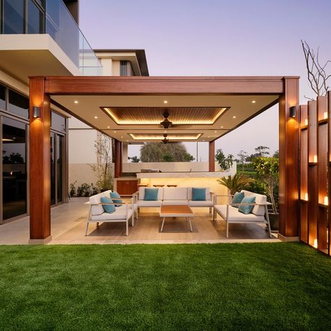 Your pergola has to meet specific requirements of set back from villa boundary walls in Dubai in most communities. We’ve built pergolas across Dubai that meet these requirements for over 15 years. A pergola is a solid wooden shade structure, water proof or sun resistant that protects you from the sun and rain, allowing you to enjoy your outdoor living space all year long. Our professional designers and builders can create a customized pergola that fits your specific needs and lifestyle. Types Of Pergolas, Patio With Roof, Pergola Patio Decor Ideas, Pergola Patio Attached To House, Patio Attached To House, Apartment Backyard, Rustic Pergola, Light Colored Furniture, Rustic Patio