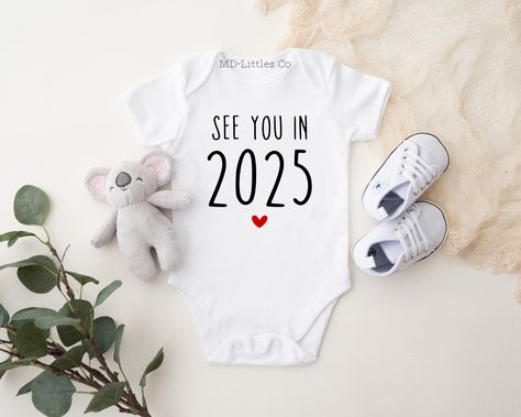 See you in 2025 Simple Pregnancy Announcement Onesie® ❣️HOW TO ORDER -Choose your size and style from the drop down menus (available sizes and styles are listed in the photos) -Add listing to your cart -Double check your address and make sure it is correct when going through checkout ✨IMPORTANT ONESIE® INFO I use Gerber onesies®, which can run small. I would suggest sizing up for your little to have more room. If the size and style you order is out of stock, I will do my best to fill your order using a different brand. If brand is important to you, please message me before ordering, and I will be happy to tell you what I will use for your order! 📦SHIPPING AND RUSH OPTIONS For US orders, I offer faster shipping options. This does not speed up production. If you would like your order rushed