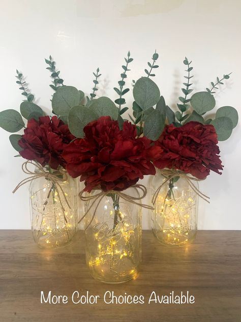 Burgundy Floral Table Centerpiece, Lighted Mason Jar Wedding Centerpieces Farmhouse Table Decor by TheCraftingJar on Etsy Red And Gray Wedding Centerpieces, Red Floral Table Centerpieces, Simple Wedding Centerpieces No Flowers, Flowers For Centerpieces Simple, Simple Floral Centerpieces Mason Jars, Maroon Flower Centerpieces, Burgundy And Green Wedding Centerpieces, Mason Jar Centerpieces For Fall Weddings, Rustic Burgundy Wedding Centerpieces