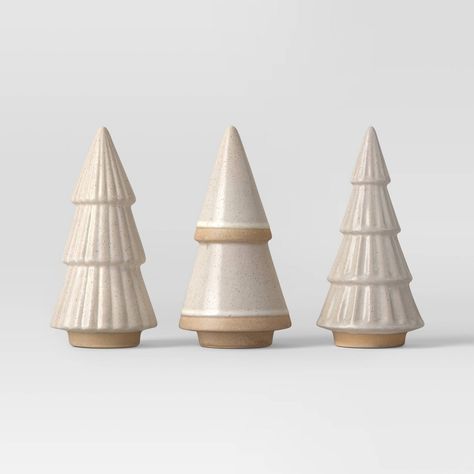 Add classic accents to your holiday decor this Christmas with the 3-Piece Ceramic Christmas Tree Figurine Set from Wondershop™. Made of ceramic, this pack includes three white Christmas trees with beautiful designs to add festive cheer to your home. Place these figurines solo on a mantel, coffee table or console table or mix and match with other holiday decor. Welcome to the Wondershop™. Shelf Placement, Painted Pinecones, Target Holiday, Christmas Tabletop, White Christmas Trees, Silver Bowl, Christmas Snow Globes, Glass Jar Candles, Ceramic Christmas Trees