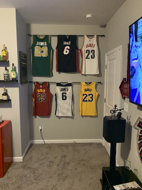 Framed Jerseys On Wall Bedroom, Jersey On Wall Ideas, Shelves For Sports Memorabilia, Jersey Storage Ideas, Jersey Decorating Ideas, Jersey Room Decor, Hang Jersey On Wall Ideas, How To Hang Jerseys On Wall, Display Jerseys On Wall