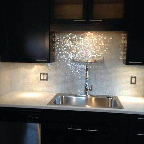 We hope your week Sparkles & Shines! This kitchen backsplash twinkles with iridescent mosaic glass tile and glitter grout. Get your sparkle on with Gold or Silver glitter grout. Studio Tile and Stone has dozens of glitter grout color choices. We''ll  help you coordinate backsplash tile and sparkly grout with your cabinets and countertops. #studiotileandstone #glittergrout #spraklygrout #suntreefl #kitchenbacksplash #tiletips #tiledesign #viera #exploreviera #satellitebeach #saltlife #ihaveathing Backsplash Options, Glitter Paint For Walls, Practical Furniture, Glass Tile Backsplash, Granite Kitchen, Beautiful Kitchen, White Cloud, Tile Ideas, Remodels