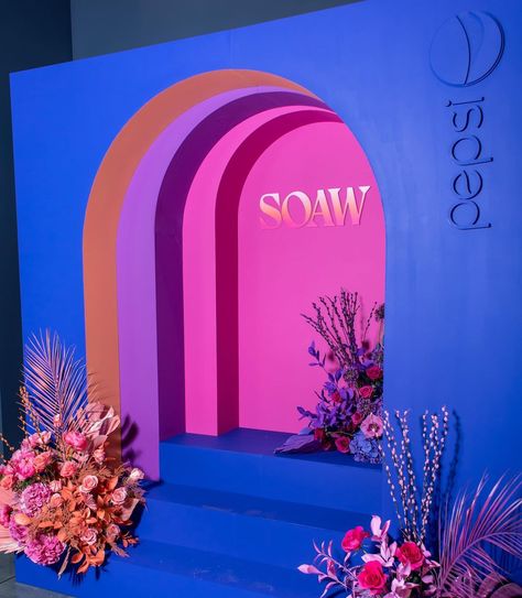 Every design has a story. This photo backdrop was inspired by a retail installation I saw. There are 3 levels of arches which gives it dimension and allowed for us to use the event colors so you see them at different angles