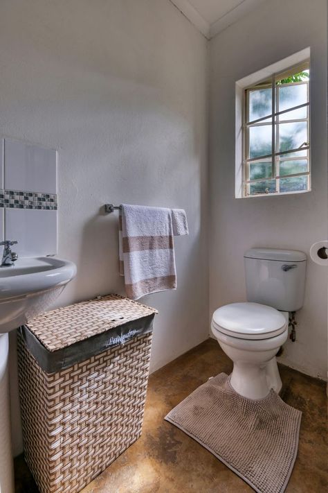 Discover simple and cozy bathroom design ideas with this clean and minimalist setup. Featuring a white sink, toilet, and a woven laundry basket, this bathroom is perfect for small spaces. The natural light from the window adds a warm touch. Ideal for anyone looking to create a functional and inviting bathroom space. #BathroomDesign #CozyBathroom #SimpleBathroom #SmallSpaceBathroom #MinimalistBathroom Cozy Bathroom Design, Minimalist Setup, Inviting Bathroom, Sink Toilet, Woven Laundry Basket, Cozy Bathroom, Small Space Bathroom, Toilet Sink, 1st Apartment