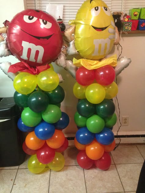 Home made balloon columns M&m Balloons, M&m Decorations, M M Party Ideas Decorations, M&m Theme Birthday Party, Primary Color Balloon Garland, Cubicle Birthday Decorations, Primary Color Balloon Arch, Trunker Treat Ideas, Office Halloween Decorations