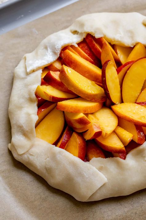 This homemade Peach Galette is so much easier to make than pie, made with an easy to make buttery, flaky crust and juicy, ripe, in season peaches. Top with my raspberry whipped cream or vanilla ice cream and get excited to enjoy this impressive yet simple to make summery dessert! #galette #peachgalette #summerdessert #galetterecipe #freeformpie #peachrecipes #krollskorner Raspberry Cream Pie, Raspberry Cream Pies, Raspberry Whip, Raspberry Whipped Cream, Peach Galette, Peach Raspberry, Galette Recipe, Lemon Ice Cream, Freeze Dried Raspberries