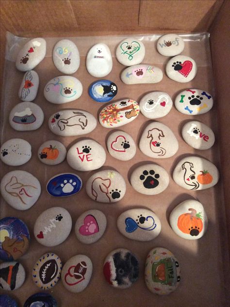 Painted rocks with dog paw print theme.  2017 kindness project. Dog Paw Rock Painting, Pet Memorial Painted Rocks, Painted Rocks Dogs Easy, Paw Print Painted Rocks, Painted Dog Rocks, Dog Painted Rocks Ideas, Dog Rock Painting Ideas, Dog Painted Rocks, Dog Rock Painting