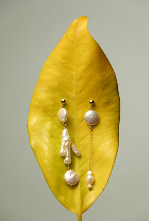 Discover the charm of individuality with our Mismatched Keshi Pearl Earrings, where no two pearls are alike. Celebrate your distinct style with these luminous Keshi pearls, each pair offering an exclusive dance of shapes and luster. One-of-a-kind: Every earring is uniquely formed, reflecting your personal flair.Radiant Luster: The all-nacre composition of Keshi pearls provides an unmatched sheen.Modern Asymmetry: Embrace a contemporary look with subtly varied pearls in each pair.Versatile Wear: Mismatched Pearl Earrings, Pearl Jewelry Photoshoot, Vintage Pearls Aesthetic, Earring Photography Ideas, Earring Product Photography, Creative Jewelry Photography Ideas, Earrings Photography Ideas, 1920s Jewellery, Jewellery Photography Ideas