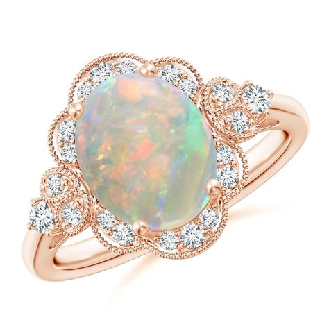 Drawing inspiration from the Victorian era, this ring holds at its heart a mysterious oval opal that tantalizes with its play of colors. Radiant diamonds form a glistening halo around the opal. Diamond studded twin leaf motifs and diamond accents adorn the shoulders of this 14k rose gold vintage opal ring. Vintage Opal Ring, Opal Ring Vintage, Oval Halo Engagement Ring, Victorian Engagement Rings, Alternative Wedding Rings, Diamond Halo Engagement Ring, Wedding Rings Halo, Tiffany Jewelry, Halo Engagement Rings