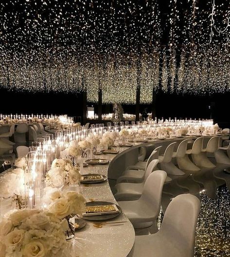 Straight out of a movie wedding reception filled with string lights and white floral centerpieces | wedding reception, wedding reception decoration, wedding reception decor ideas, wedding tablescapes, wedding table decor ideas,white wedding, total white wedding, floral centerpieces, flower arrangements, floral details, luxury wedding, glam wedding decor, glamorous wedding, indoor wedding reception, 2023 wedding, sky high centerpieces, wedding tablescapes, roses, string lights decor Lighting In Wedding Tent, Alison Events Wedding, Fun Elegant Wedding, Magical Wedding Decor, Avant Garde Wedding Decor, Over The Top Wedding Dress, Luxury Black Wedding, Wedding Extravagant, Extravagant Wedding Decor