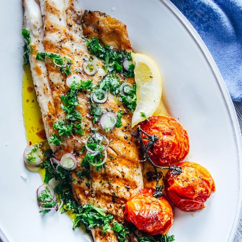 The striped bass has a nice smoky flavor off of the grill that is cut by the ... Striped Bass Recipe, Bass Recipe, Blistered Tomatoes, Striped Bass, Seafood Dinner, Fish Dishes, Seafood Dishes, The Grill, Fish And Seafood