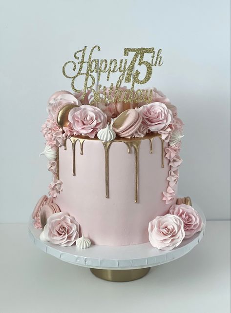 Pink cake with a gold drip. On top and down the sides are sugar roses, macarons, and meringues. On top there is a gold and sparkly cake topper that reads “Happy 75th Birthday” 75th Cake Ideas, Cakes For 75th Birthday Mom, Birthday Cake For 75 Woman, 75th Cake Topper, Cake 75th Birthday For Women, Cake Ideas For 75th Birthday, 75th Bday Cake For Mom, 75 Th Birthday Cake Designs, Pink 70th Birthday Cake