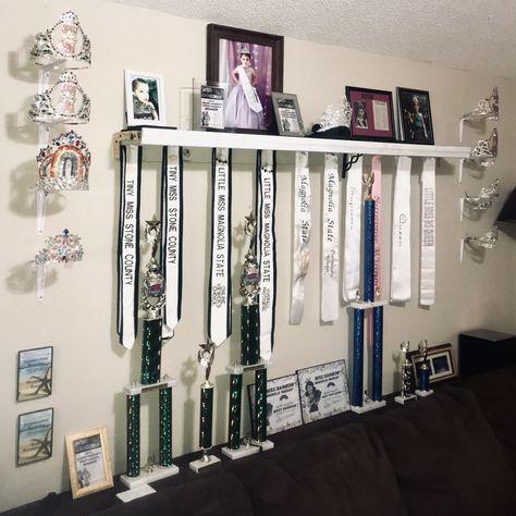 Pageant Crown and Sash Display using shelf brackets Pageant Sash Display, Crown And Sash Display, Dance Awards Display Ideas, Crown Display Ideas, Pageant Room, Awards Display Wall, Pageant Crown Display Ideas, Trophy Display Ideas, Jackie Sullivan