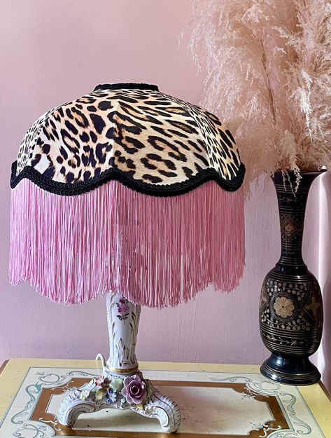 "Well hello Veronica!  This seductive and luxurious fringe lampshade is handmade from the softest leopard print velvet, surrounded in hand dyed bubblegum pink silk fringe and framed with thick black braid! Lined beautifully in satin using traditional pleating techniques, this lampshade is beautiful inside and out. Veronica is a statement piece and her true beauty shines when lit up.  Definitely no filter needed.   (Lamp base not included) This lampshade is a 12 inch frame which is perfect for a Luxury Lamp, Burlesque Room, Lamp Pink, Feather Lamps, Fringe Lamps, Fringe Lampshade, Fringe Lamp, Lamp With Fringe, Ostrich Fringe Lamp