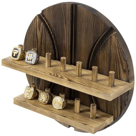 PRICES MAY VARY. 2-tiered wall mounted wooden basketball-themed jewelry storage display shelf and ring holder to display sports championship rings Featuring 12 built-in pegs that each hold a single large sports championship ring, or several men’s or women’s standard jewelry rings Constructed of solid wood with a rustic burnt brown finish and a cutout basketball cutout backing with aesthetic carved out lines for visually stunning décor Easily mount this ring storage organizer to a flat wall surfa Basketball Ring, Jewellery Storage Display, Nba Championship, Hanging Jewelry Organizer, Ring Storage, Championship Rings, Storage Display, Basketball Fans, Ring Displays