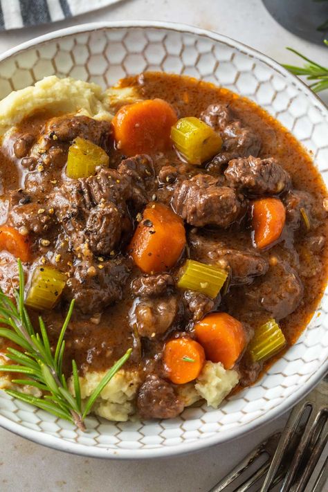 This easy, red wine beef stew is tender and delicious! It's filled with veggies and seasoned with rosemary and thyme - creating a hearty comfort food. Serve it over dairy free mashed potatoes or with drop biscuits complete meal! Stew With Mashed Potatoes, Wine Beef Stew, Red Wine Beef Stew, Red Wine Beef, Dairy Free Mashed Potatoes, Irish Beef Stew, Irish Beef, Rosemary And Thyme, Hearty Comfort Food