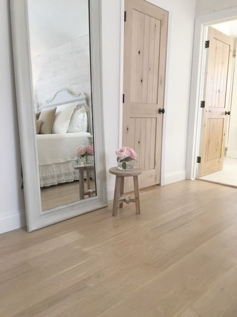 My master bedroom with white oak hardwood flooring and rustic alder doors - Hello Lovely Studio. Romantic Bedroom Lighting, Alder Doors, Knotty Alder Doors, Cottage Style Furniture, White Oak Flooring, Bedroom Details, White Bedroom Decor, Stained Doors, French Country Bedrooms