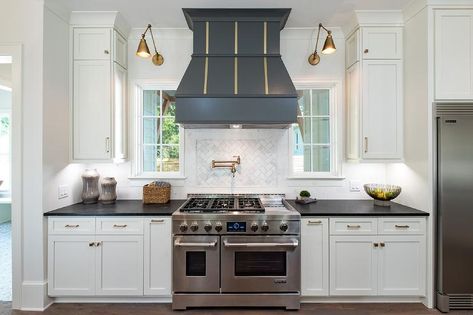 Stunning cooktop designed with a black French wood range hood accented with brass trim. Metal Range Hood, Wood Range Hood, Custom Range Hood, Kitchen Hoods, Transitional Kitchen, Kitchen Inspiration Design, Farmhouse Style House, Range Hood, White Cabinets