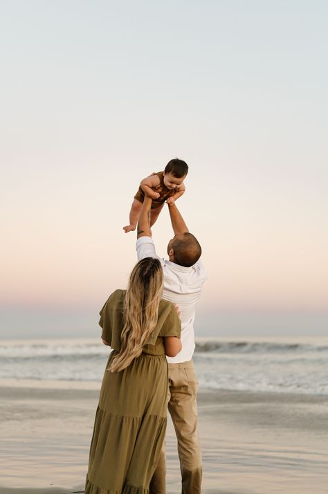 San Diego family photos of young family together on the beach at sunset with dad holding toddler boy up to the sky as mom looks from behind at Coronado Beach California Golden Hour Beach Photoshoot, Sunset Family Photoshoot, Photoshoot Beach Family, Photoshoot With Horses, Family Photoshoot Beach, Field Family Photos, Golden Hour Field, Sunset Beach Photoshoot, Pink And Blue Gradient