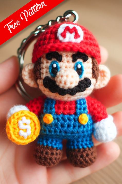 This mini crochet Mario keychain captures the essence of the beloved video game character with a whimsical charm that is both playful and skillfully created. Crochet Super Mario Keychain, Super Mario Free Crochet Pattern, Crochet Marvel Keychain, Super Mario Crochet Patterns Free, Crochet Mario Characters, Mario Crochet Pattern Free, Crochet Patterns Keychain, Amigurumi Keychain Free Pattern, Mario Keychain