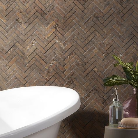 Buy Portrait Copper 1x4 Herringbone Matte Porcelain Mosaic Tile. Best price guarantee and 365 day returns when you shop at TileBar. About The Tile: Create your masterpiece with the Portrait Copper Herringbone Matte Porcelain Mosaic collection. This full-bodied porcelain features metallic infused hues of oxidized concrete that offers a multi-color expression of depth and artistic style. This herringbone mosaic tile format can fit anywhere, from backsplashes, showers, fireplaces, entryways, and mo Black White And Copper Bathroom, Rustic Tile Bathroom, Rustic Tile Fireplace, Western Bathroom Tile, Herringbone Tile Floor Entryway, Copper Tile Backsplash Kitchen, Brown Tile Fireplace, Western Kitchen Backsplash, Cabin Kitchen Backsplash