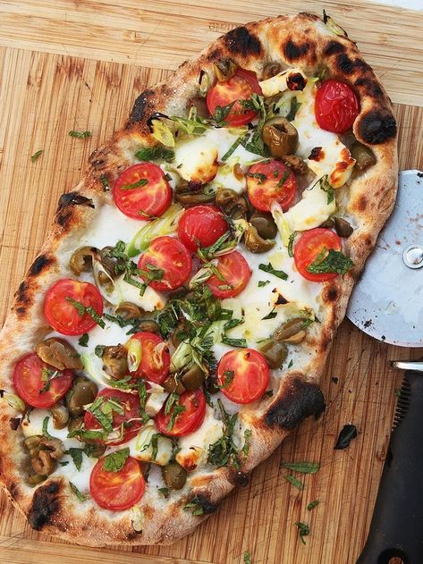 Pizza With Cherry Tomatoes, Halloumi, Olives, and Mint | Halloumi, tomatoes, and olives aren't exactly an unheard of pairing, but you probably haven't seen them on pizza. That's partly because halloumi is a tricky pizza topping—it doesn't melt like you want pizza cheese to, so it's best to think of it like another topping and scatter it on top of a bed of mozzarella. #pizza #pizzarecipes #homemaderecipes #seriouseats #recipes Halloumi Pizza Recipe, Halloumi Pizza, Halloumi Tomato, Gourmet Pizza Recipes, Vegetarian Pizza Recipe, Serious Eats Recipes, Italian Lunch, Mozzarella Pizza, Tomatoes Mozzarella