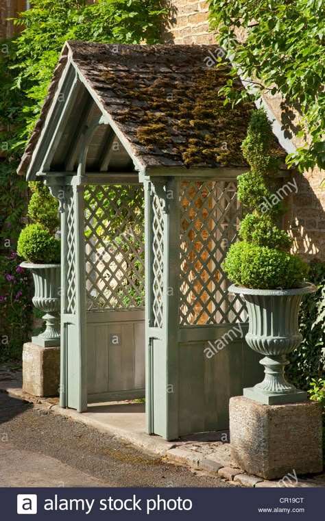 Download this stock image: wooden Porch with lattice sides of Cotswold cottage flanked by box spiral Topiary in stone urns, England - cr19ct from Alamy's library of millions of high resolution stock photos, illustrations and vectors. Front Door Trellis, Trellis Porch, Box Topiary, Porch Trellis, Cottage Front Doors, Porch Canopy, Porch Kits, Cotswold Cottage, Beach Canopy