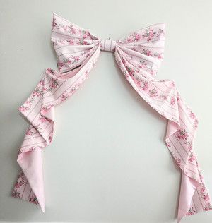 How to Make a Big Bow for the Wall - at home with Ashley Loveshack Fancy Theme Party, Diy Bow Decorations, How To Make A Bow Out Of Fabric, Bow Photo Backdrop, Bow Backdrop Ideas, Big Bow Decoration, Bow Bedroom Ideas, Diy Big Bows Decoration, Bow Room Aesthetic