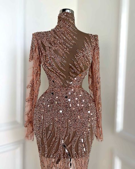 To order these stunning rose gold embellished dresses, DM us @reineecouture. These breathtaking rose gold gowns are designed to captivate with intricate detailing and luxurious embellishments. The first dress features a sleeveless, fitted design with a dazzling array of crystals and beads, creating a shimmering effect that radiates elegance. The second dress takes it to the next level with its dramatic one-shoulder ruffle and sheer crystal-embellished bodice, perfect for a grand entrance. Th... Rose Gold Gown, Cocktail Saree, Gold Gowns, Embellished Dresses, Nude Gown, Second Dress, Rose Gold Dress, Gold Gown, Blue Cocktails