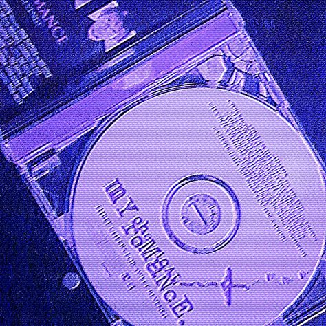 An open My Chemical Romance CD is shown diagonally across the screen. There is a purple tint to the whole image. Purple Webcore, Pfp Cybercore, Purple Cybercore, Cybercore Pfp, Aesthetic Dark Purple, Y2k Webcore, Pfp Purple, Cybercore Icons, Webcore Aesthetic