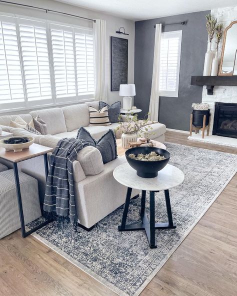 Beige sectional sofa is placed on a grey vintage rug under a bank of windows with white shutters. A round white marble and black metal end table is perched next to the sofa in this grey modern farmhouse living room. Grey Modern Farmhouse Living Room, Grey Modern Farmhouse, Grey Sectional Couch, Farmhouse Dining Room Design, Gray Sectional Living Room, Blue Grey Living Room, Sectional Living Room Layout, Room Decor Easy, Sectional Sofa Beige