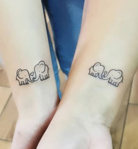 Simple Elephant Tattoos in Popular Styles for Inspiration | Inku Paw Elephant Tattoos Couple, Mother And Daughter Elephant Tattoo, Twin Elephant Tattoo, Mother Daughter Frog Tattoos, Sister Elephant Tattoos, Mom Daughter Tattoos Elephant, Couple Elephant Tattoo, Elephant Sister Tattoo, Elephant Mother Daughter Tattoo