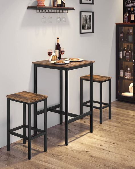 Combining steel with particleboard and enhanced by H-shaped stretcher bars, this bar table is built with a stable structure with high strength. This square pub table is functional as a breakfast table, dining table, or mini coffee bar, while the 23.6”D x 23.6”W x 35.4”H size lets it easily fit in tiny kitchens, spare corners, or by the window for a romantic night with your other half. High Top Pub Table, for Living Room Study, Rustic Brown and Black Table Haute Bar, Kitchen Bar Table, Small Kitchen Tables, Bar Table And Stools, Color Table, Bar Table Sets, Tall Table, Table Haute, Industrial Table