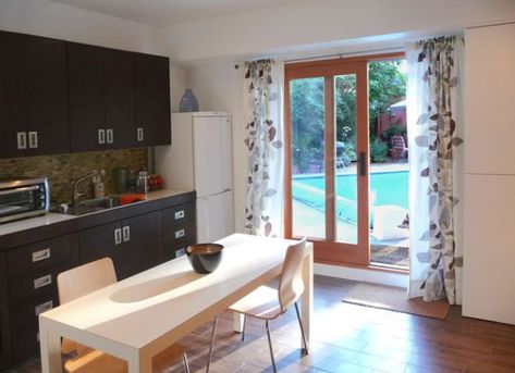 Sliding glass doors in the kitchen keep you viusally connected with the backyard Attached Garage Conversion, Kitchen Patio Doors, Studio Apartment Kitchen, Sliding Glass Door Curtains, Garage Guest House, Small Bedroom Remodel, Patio Door Curtains, Garage Renovation, Garage Remodel