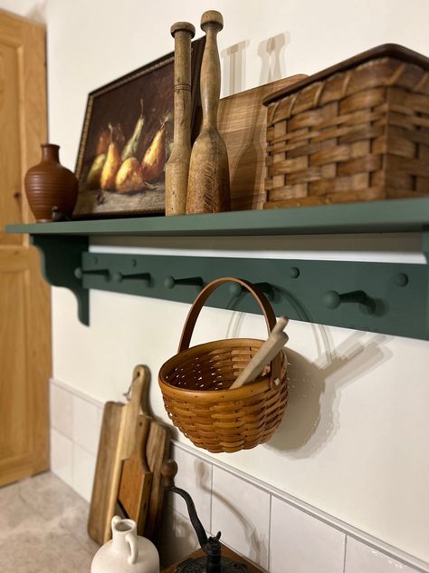 Add character and functionality to your space with this handcrafted, pine wood peg shelf. Wooden shaker peg shelf with hand crafted corbel ends. Pictured in Basil Green 36" (5 peg), this is a versatile shelf that provides both character and functionality to your space. The accent ends on our shelves are hand crafted and not something that can be purchased in a big box store. Each piece is built and painted by hand in our shop. Variations in wood grain make each piece slightly different which add Shaker Peg Rail Entryway, Shelf Picture Display, Wood Shelf Kitchen, Shaker Shelf, Shaker Peg Shelf, Amazing Gray Paint, Green Farmhouse Kitchen, Dining Room Shelf, Peg Coat Rack