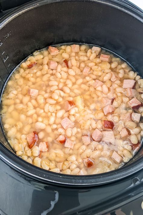 Take a trip down memory lane with this classic Old Fashioned Ham and Beans Stew. Made with slow-cooked ham, tender navy beans and a blend of spices, this stew is the ultimate comfort food. Perfect for a chilly day or a casual family dinner. Serve with crusty bread for a satisfying meal. Ham And Bean Soup Recipes Stovetop, Ham And Beans Stovetop, Old Fashioned Ham, Navy Beans And Ham, Country Fried Pork Chops, Crockpot Ham And Beans, Slow Cooked Ham, Canned Beans Recipe, White Beans And Ham