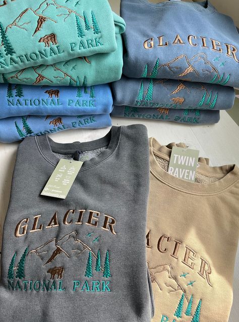 We sell primarily on our website where we offer free shipping and more colour options. TwinRavenCo Outfit yourself for a wild ride with our Glacier National Park Crew, boasting a simple yet stunning mountain landscape. Conquer the terrain in comfort and style - this quality piece is an outdoorsy essential! Available in so many colours, you'll feel fab from first light 'til night. 𓄿 Pigment Dyed giving that perfect vintage look- -please allow for very slight colour variation.  𓄿 Unisex- standard fit 𓄿 Split stitch double needle sewing on all seams 𓄿 Twill neck tape 𓄿 1 x 1 ribbing at neck, cuffs and waistband 𓄿 The highest quality, sustainable threads are used. This embroidery is made to last! * Check out our socials for discounts, new releases, and to see how we run our shop: TwinRav Vintage Sweatshirt Outfit, Granola Outfits Winter, Granola Outfits, National Park Sweatshirt, Vintage Crew Neck, Split Stitch, Outdoorsy Style, Music Festival Outfits, Embroidered Crewneck