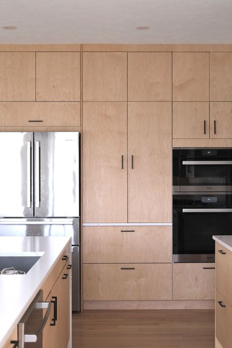 This light-filled project in Omaha, NE 🇺🇸, features Plykea Maple and Fenix Bianco Kos kitchen fronts, with edge banded cover panels and a mix of black edge pull and D pull handles.   #plywoodkitchen #birchplywood #plywood #ikeahack #kitchenideas #kitchentrends #fenixforinteriors #maple  Design: IKD - Inspired Kitchen Design Oak Kitchen Black Handles, Plykea Kitchen, Birch Plywood Cabinets, Flat Front Kitchen Cabinets, Flat Panel Kitchen Cabinets, Ply Kitchen, Inset Kitchen Cabinets, Kitchen Laminate, Villa Kitchen