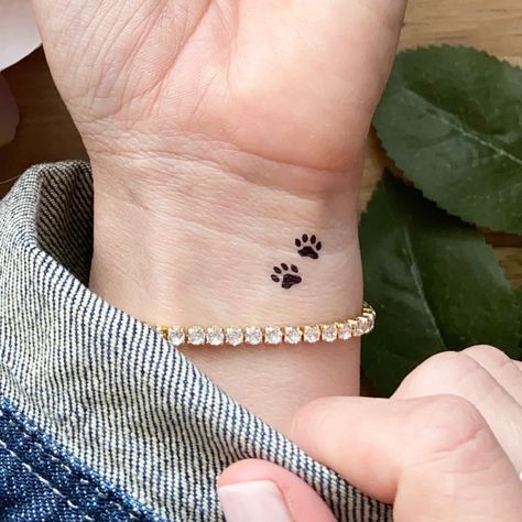 Beagle Paw Print Tattoo, Pet Dog Tattoo Designs, Tattoo Designs Dog Paw, Cross With Paw Print Tattoo, Ankle Tattoo Paw Print, Make A Difference Tattoo, Dog Paw Tattoo On Finger, Four Paw Print Tattoo, Dog Tribute Tattoo Small Dachshund