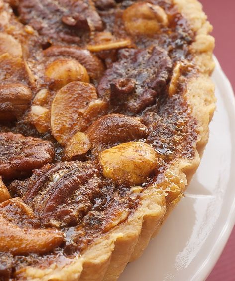 Take your pecan pie game to the next level with this Mixed Nut Tart. With a variety of nuts and notes of caramel, it's the perfect sweet-and-salty dessert! Nut Tart, Nut Pie, Pie Game, Salty Desserts, Yummy Deserts, Holiday Baking Recipes, Chocolate Crust, Pastry Pie, Thanksgiving Recipes Side Dishes