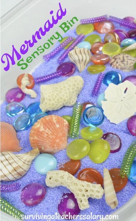 Mermaid Sensory bin is magical preschool play! Just bring your creative imagination and fill a container with seashells, purple and green sand, glass beads, and other items! My daughter went crazy over this diy mermaid craft activity! We're going to use it at her mermaid birthday party too! The kids will LOVE it! #mermaid #sensory #sensorybin #sensoryplay #sensoryrecipe #play #preschool #kids #pretendplay #imagination #imagine #beach Mermaid Sensory Bin, Mermaid Sensory, Sensory Basket, Mermaid Craft, Fairy Tales Preschool, Craft For All Ages, Play Preschool, Preschool Play, Crafts For Preschoolers