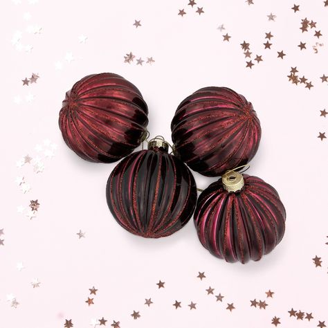 Crafted with meticulous attention to detail, these ornaments boast a stunning maroon hue that shines and sparkles when caught by the twinkle of holiday lights. The lined ribbed texture, adds dimension and visual appeal to your holiday trees. Adorn your wreaths and garlands to instantly elevate your festive ambiance, or add to a centerpiece. Pair with our maroon glass onion holiday ornament set for a complete look. Product Features: Set of 4 holiday glass ball ornaments Maroon ornaments with a ri Maroon Christmas Tree, Glass Ball Christmas Ornaments, Moody Christmas, Glass Onion, Mid Century Modern Christmas, Holiday Trees, Christmas Themes Decorations, Glass Ball Ornaments, Wreaths And Garlands