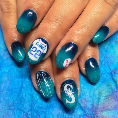 Sabella "Bella" Snyder on Instagram: “Mariners spring training nails for @itzeldenise ⚾️ Hard gel overlay with Mani-Q ombré and hand painted designs @youngnailsinc with a dust of @wildflowersnails glitter #qualitynails #nailsbybella #synergygel #youngnailsgel #yngel #youngnailsinc #youngnails #handpainted #handpaint #art #nails #nailart #nailartdesigns #gelnails #gelmani #gelnailart #LAnails #ynmentor #yn #nailtechnician #nailtech #showmethemani #LAnailartist #sweetbcreations” Spring Training Nails, Hard Gel Overlay, Baseball Nails, Seattle Mariners Baseball, Hand Painted Designs, Gel Overlay, La Nails, Nail Prices, Mirror Nails