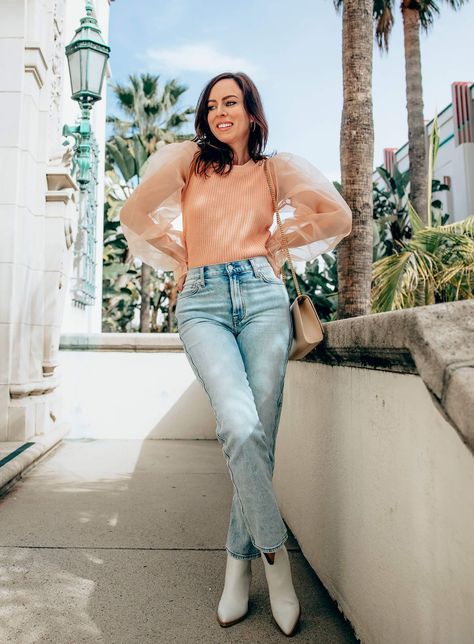 Sydne Style wears organza sleeve sweater with jeans for spring outfit ideas #sheer #sleeves #jeans #booties #peach @sydnesummer Peach Outfit Ideas, Peach Top Outfits, Peach Outfit, Celebrity Clothing, Peach Clothes, Light Color Jeans, Sheer Sleeves Top, Peach Top, Organza Sleeves