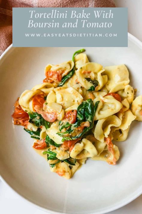 This easy tortellini bake is an upgrade from your standard baked tortellini recipe. Bake herby Boursin cheese with cherry tomatoes, then toss in fresh spinach and tortellini for hot, delicious comfort food. #tortellinibake #bakedtortellini Tortellini Bake With Boursin & Tomato, Boursin Cheese Tortellini Spinach, Boursin Tortellini Spinach, Boursin Cheese Pasta Tortellini, Boursin Cheese Recipes Tortellini, Boursin And Tomato Tortellini, Fresh Cheese Tortellini Recipes, Boursin Tortellini Bake, Light Tortellini Recipes