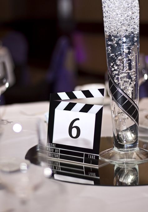 Night At The Movies Prom Theme, Hollywood Theme Centerpieces, Lights Camera Auction Theme, Movie Centerpieces Wedding, Black And White Movie Party, Movie Theme Table Decorations, Movie Table Numbers, Movie Themed Wedding Centerpieces, Movie Themed Table Centerpieces